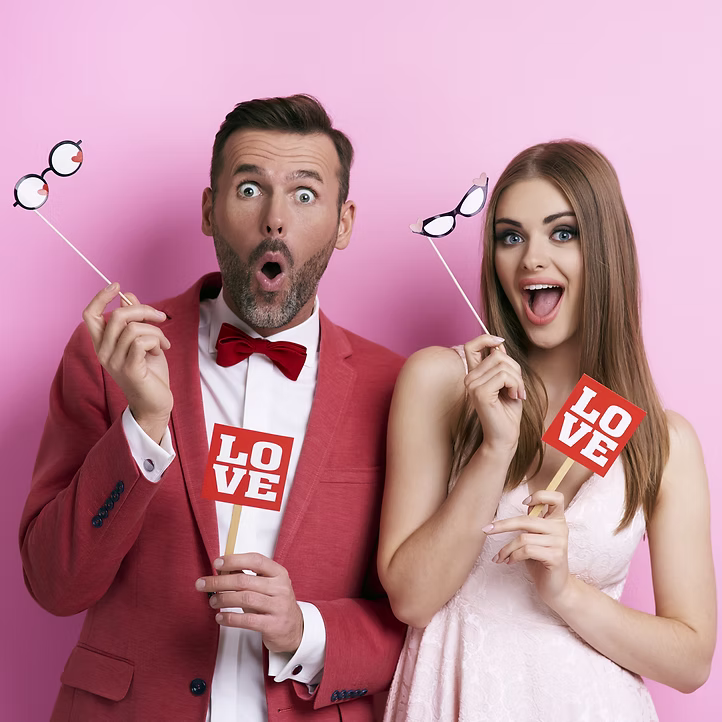 Couple with photo booth props in studio